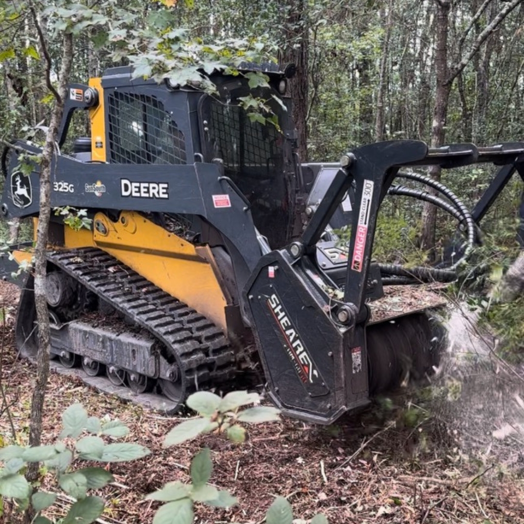 Skid steer drum mulcher on job site